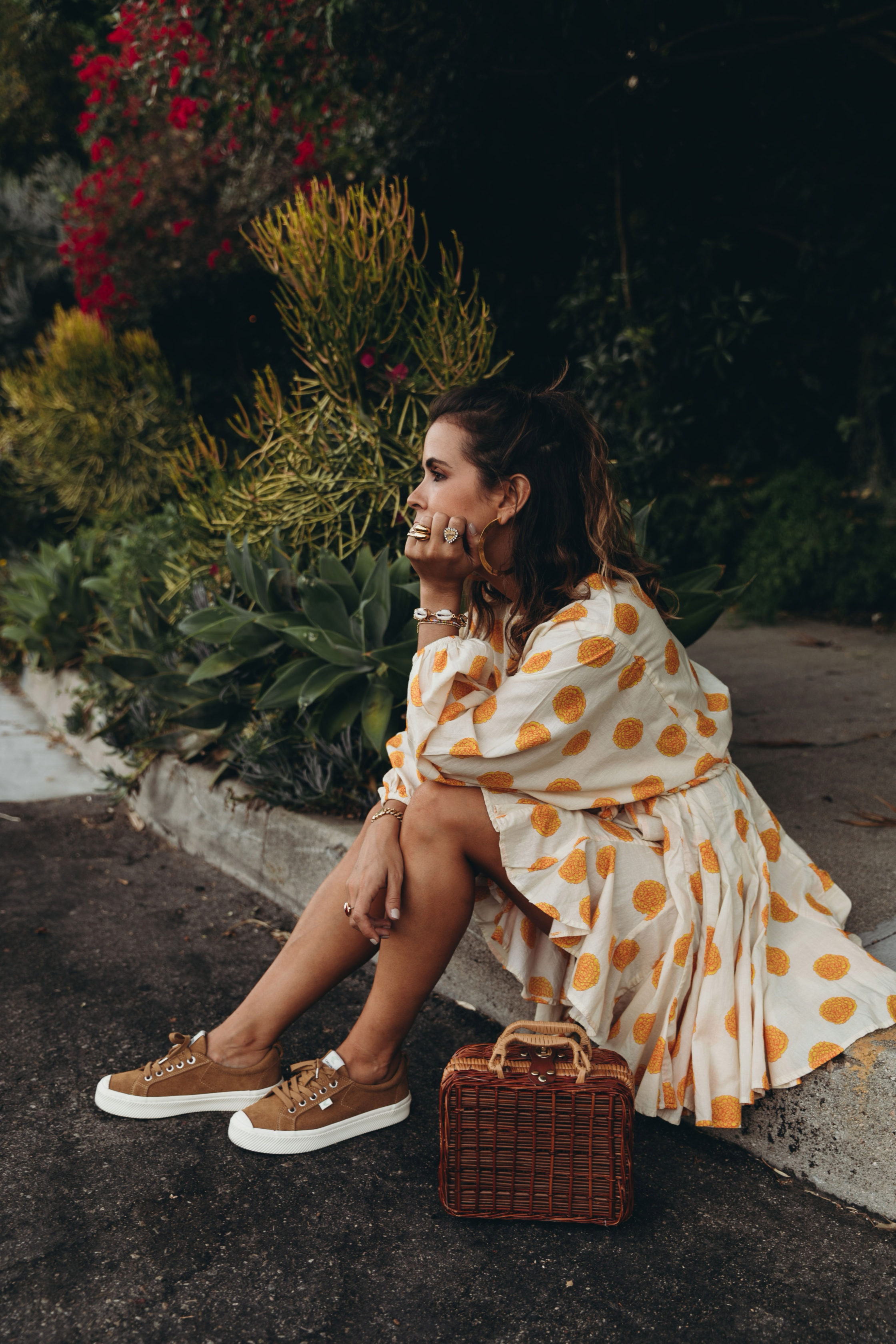 Sara Escudero of Collage Vintage wearing a Rhode dress and Cariuma suede sneakers